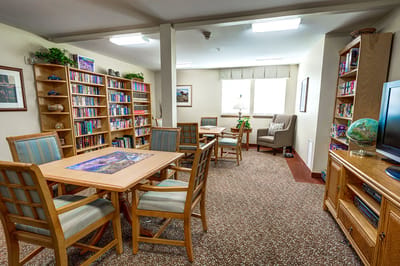 Bright common area with bookshelves and seating