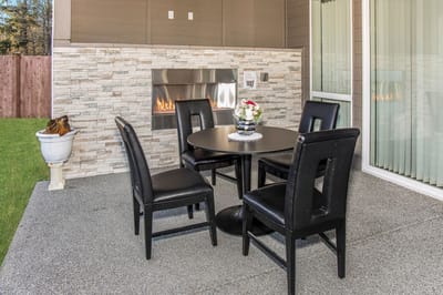 Outdoor patio area with a table and chairs