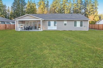 A cozy back view of a senior living facility with a lawn