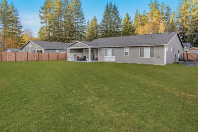 Exterior view of a senior living facility with a backyard