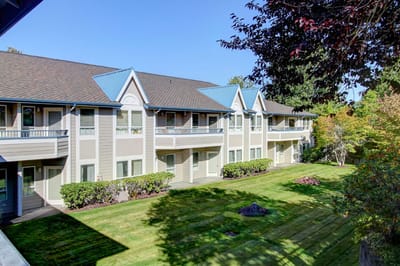 Exterior view of Clearbrook Inn with landscaped grounds