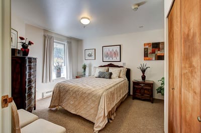 Cozy private resident room with bed and decor