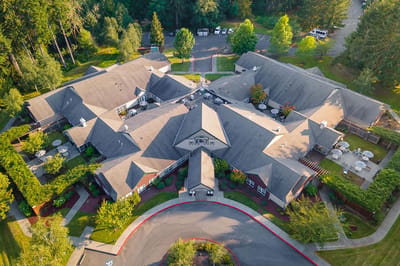 Aerial view of a senior living facility with landscaped gardens
