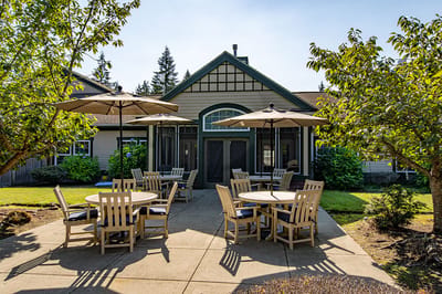 Outdoor seating area with tables and umbrellas
