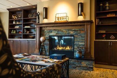 Cozy common area with a fireplace and bookshelves