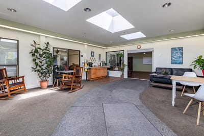 Bright interior common area with furniture and skylights