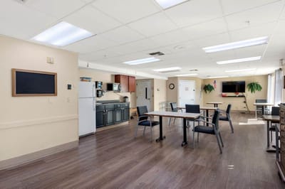 Bright common area with seating and appliances