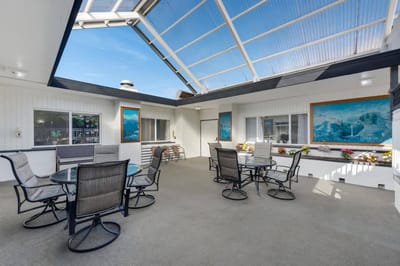 An outdoor patio space with seating and artwork