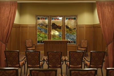 Interior view of a serene and inviting chapel with stained glass windows