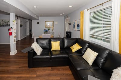 Cozy living area in a senior care facility with a black couch
