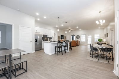 Bright and modern common area with dining tables and seating