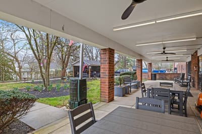 Outdoor patio area with seating and greenery