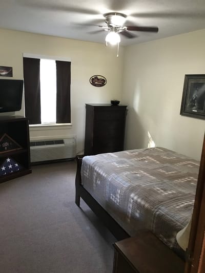 Cozy private resident room with bed and dresser
