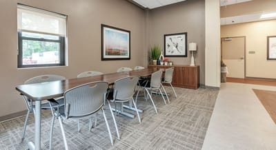 Interior view of a common area with a large table and chairs