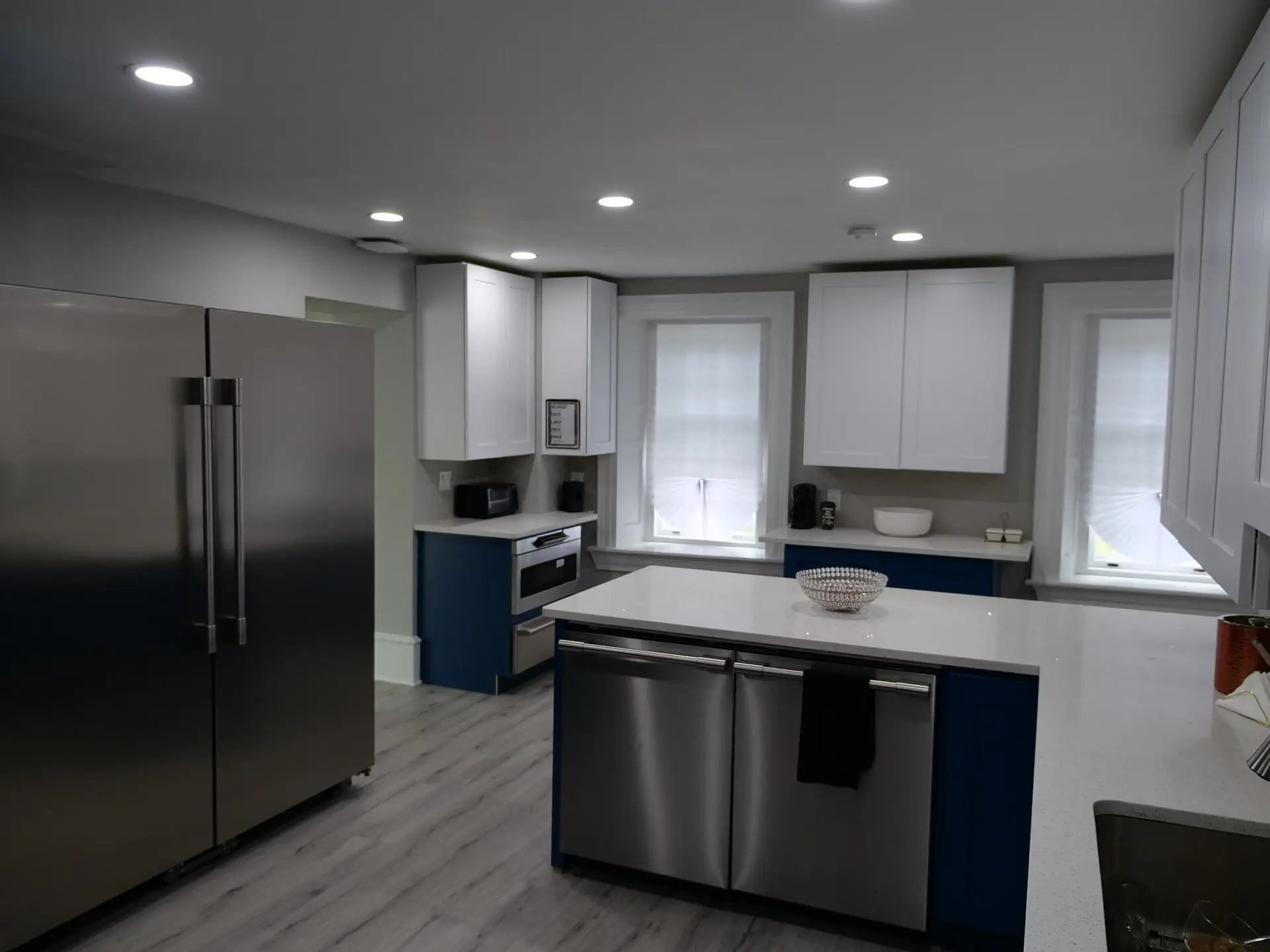 Modern kitchen interior with white cabinets and gray walls