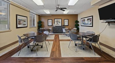 Bright dining room with tables and artwork on the walls