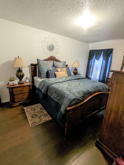 Cozy bedroom with decorative bedding and lamps
