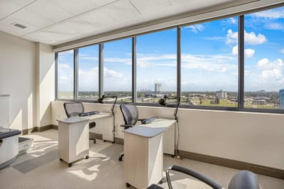 Bright interior space with large windows and workstations