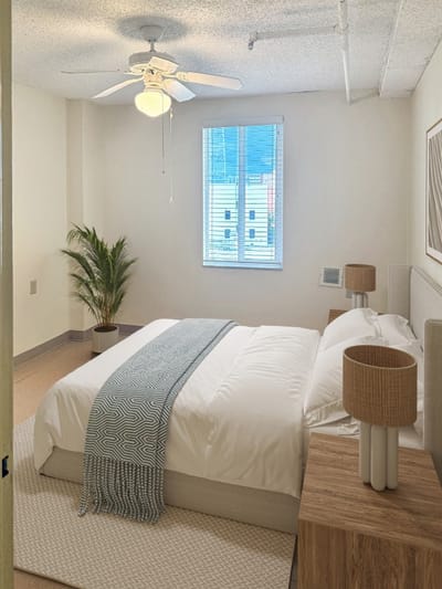 Bright, well-furnished resident room with a window