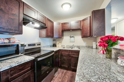 Modern kitchen space with cabinets and stainless appliances