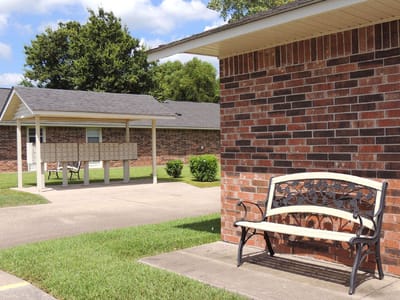 Outdoor space with a bench and building in the background
