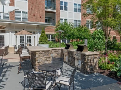 Outdoor patio area with seating and grills