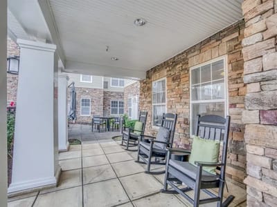 Outdoor seating area with rocking chairs and tables