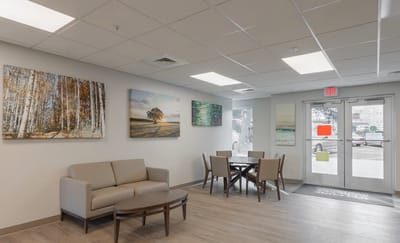 A well-lit common area with seating and artwork