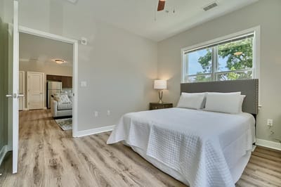 Bright, spacious private resident room with a bed and natural light