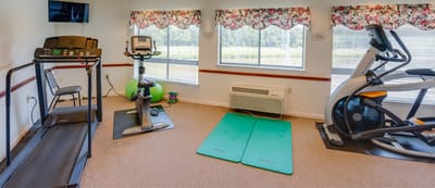 Fitness equipment in a well-lit exercise room