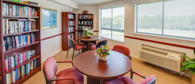 Cozy common area with bookshelves and tables