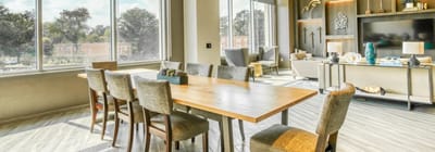 Bright common area with a large dining table and seating