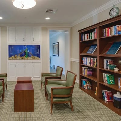 Comfortable seating area with bookshelves and aquarium