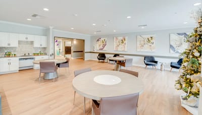 Bright common area with tables and artwork