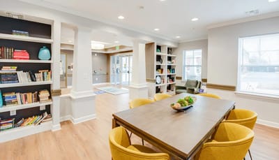 Bright common area with bookshelves and seating