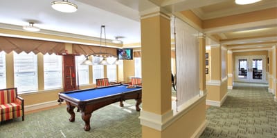 Bright common area with pool table and seating
