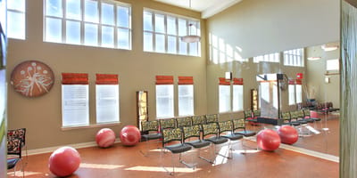 Bright, spacious activity room with exercise balls and chairs