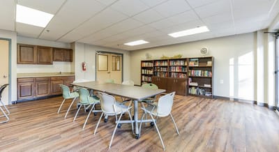 Common area with tables and bookshelves