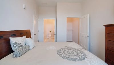 A well-decorated private resident room with bed and bathroom door
