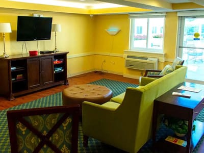 Common area with seating and television in a nursing home.