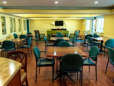 Interior view of a spacious common area with tables and chairs