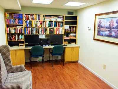 Interior of a small library with computers and bookshelves
