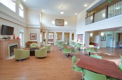 Bright common area with seating and tables for residents