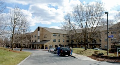 Harford Senior Housing, independent living in Bel Air, MD — Senior living facility entrance with parked cars and trees