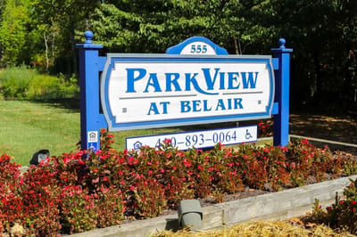 Facility sign in a landscaped area with flowers