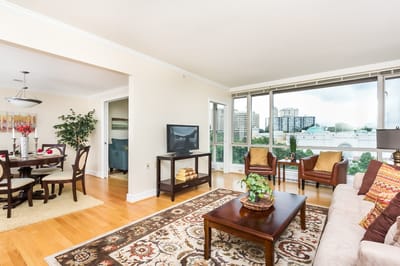 Bright common area with large windows and furniture
