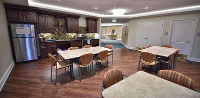 Bright dining area with tables and kitchenette