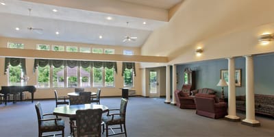 Bright common area with seating and piano