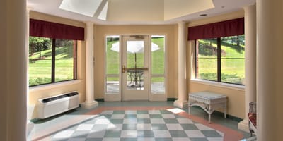 Bright entrance area with large windows and seating