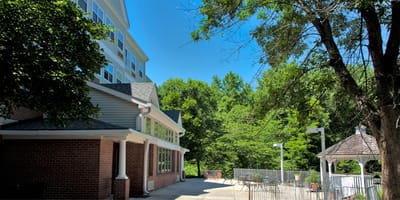Exterior view of Pin Oak Village surrounded by greenery